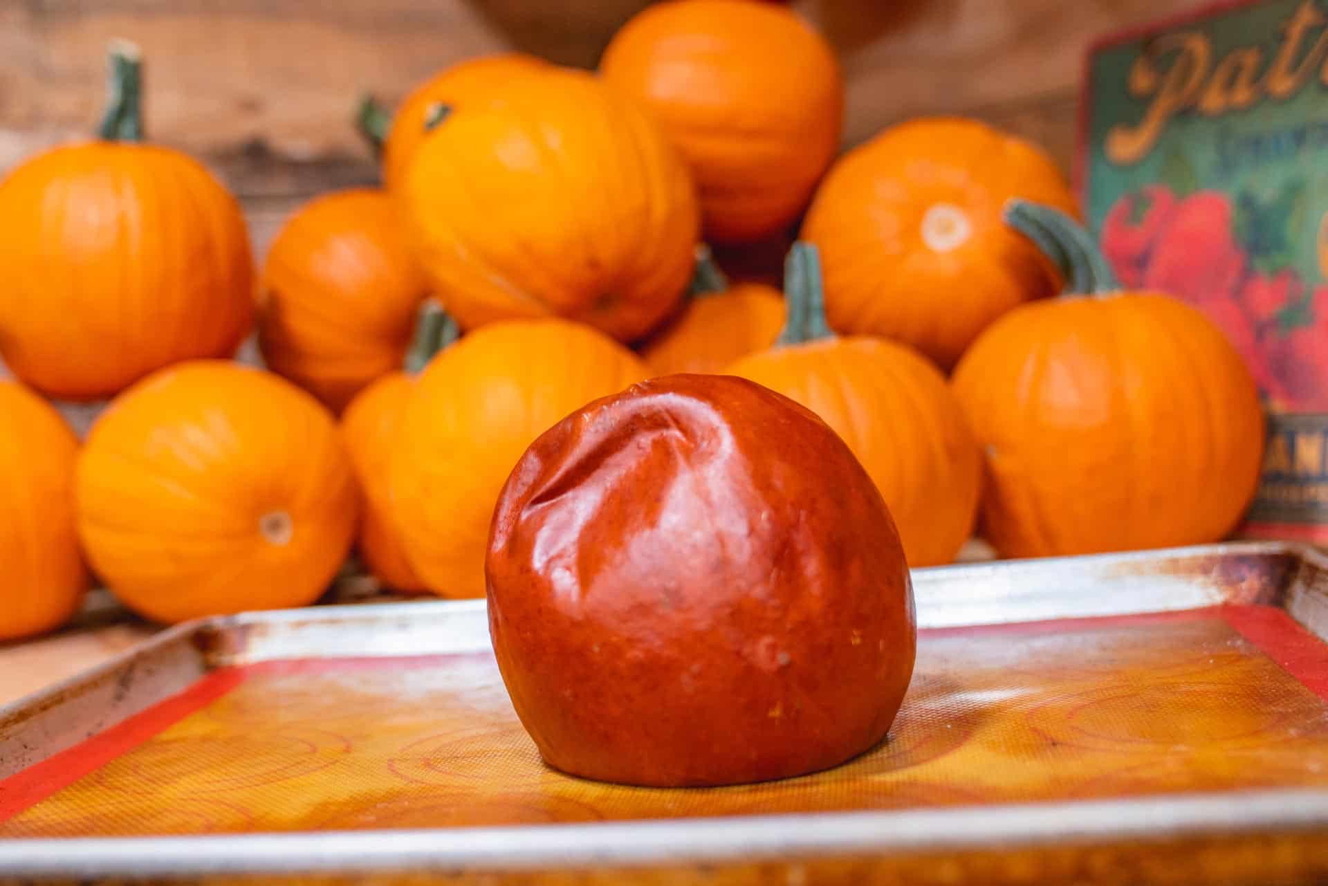 A roasted pie pumpkin on a baking sheet.