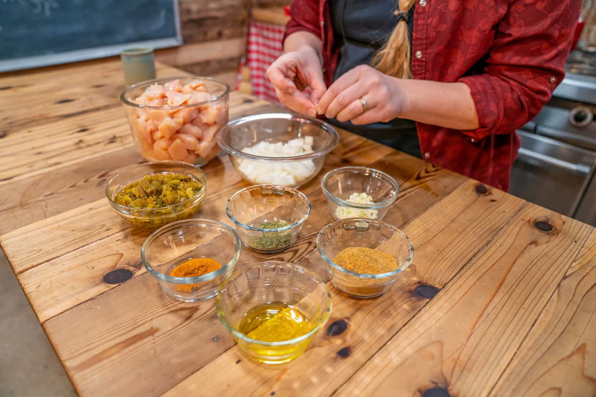 Ingredients being prepped and put into glass bowls for homemade chicken chili.