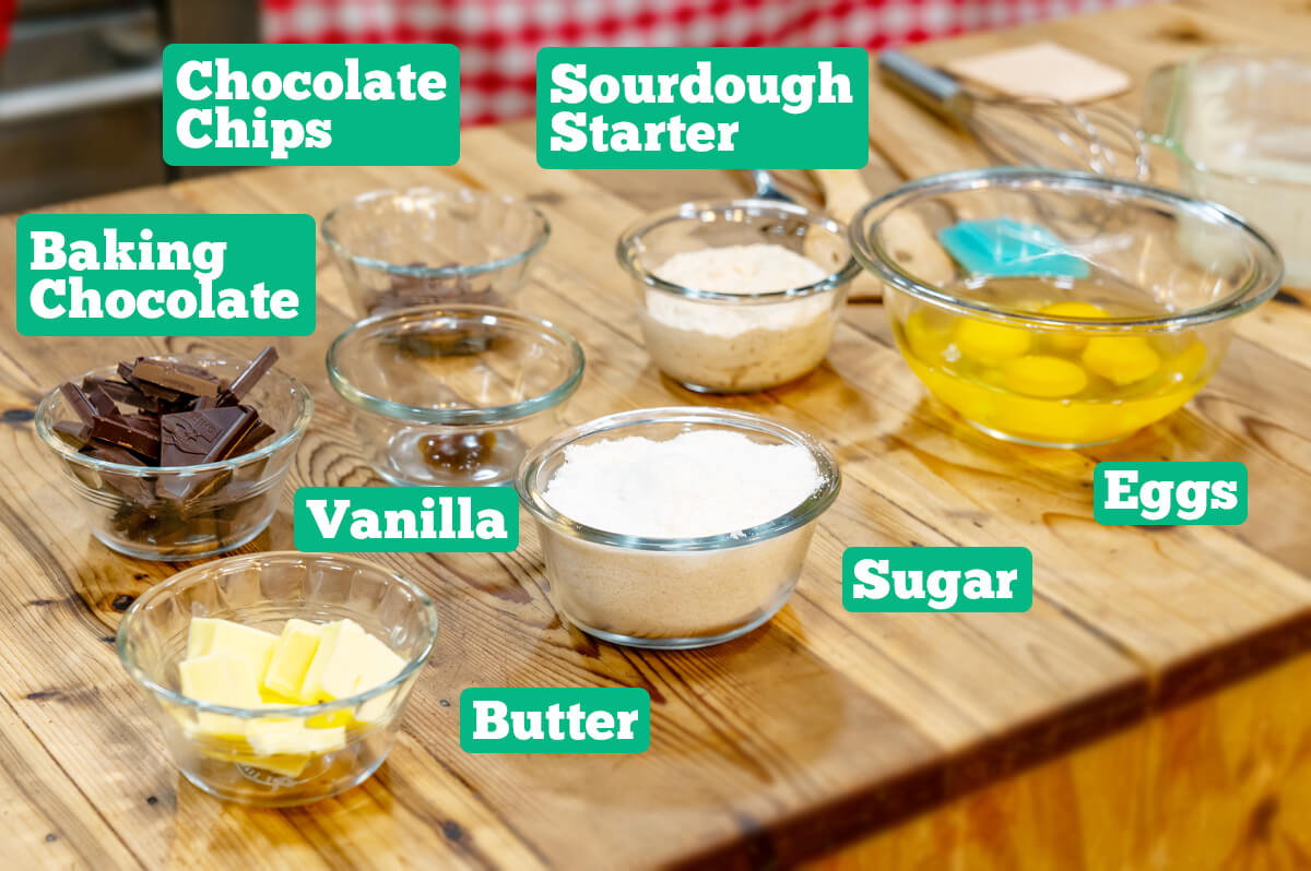Ingredients in glass bowls on a wooden counter.