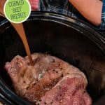 Pinterest pin for homemade corned beef with an image of a corned beef brisket in the crockpot and brine being poured over the top.