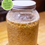 Pinterest pin on how to ferment chicken feed with an image of a gallon jar filled with chicken feed and water.