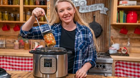 A woman pulling a jar out of the Instant Pot.