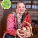 Pinterest pin for raising backyard egg-laying chickens with an image of a woman crouched in a chicken coop holding a basket of eggs.