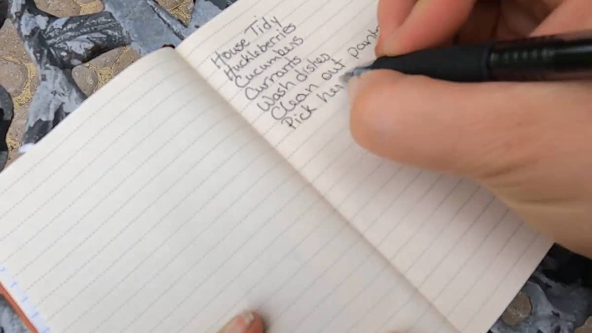 A notebook with a list of things to do written inside.