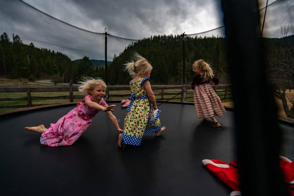 Girls jumping on a trampoline.