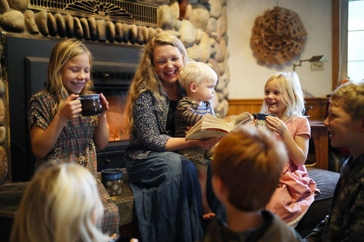 A woman reading to her children.