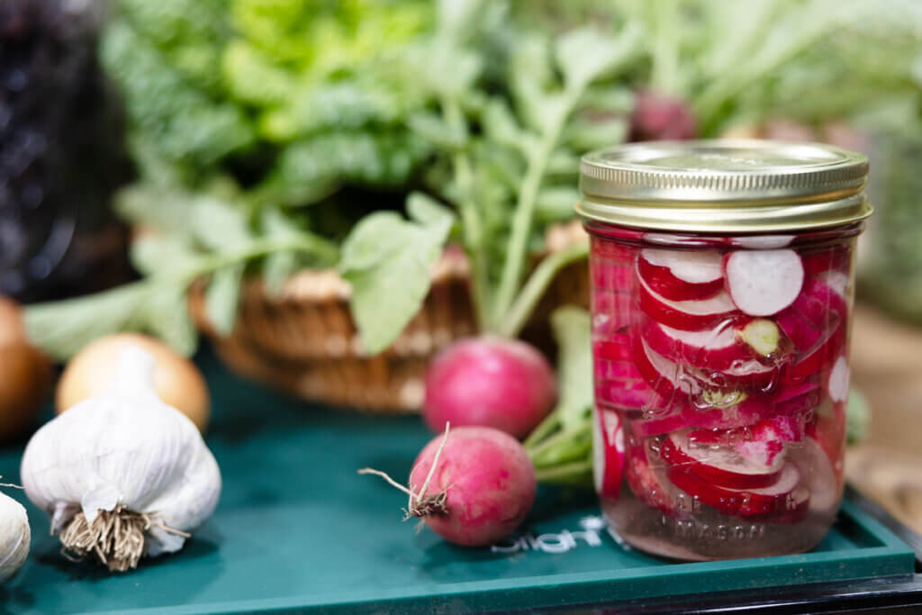 Fermented radishes in a pint jar.