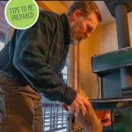 Pinterest pin for how to be prepared for a power outage. Image of a man adding wood to a wood burning cook stove.