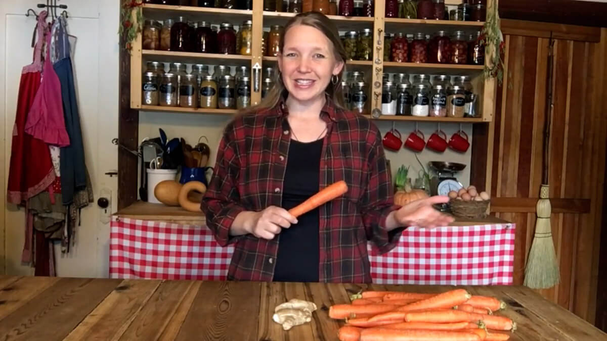 A woman holding a carrot.