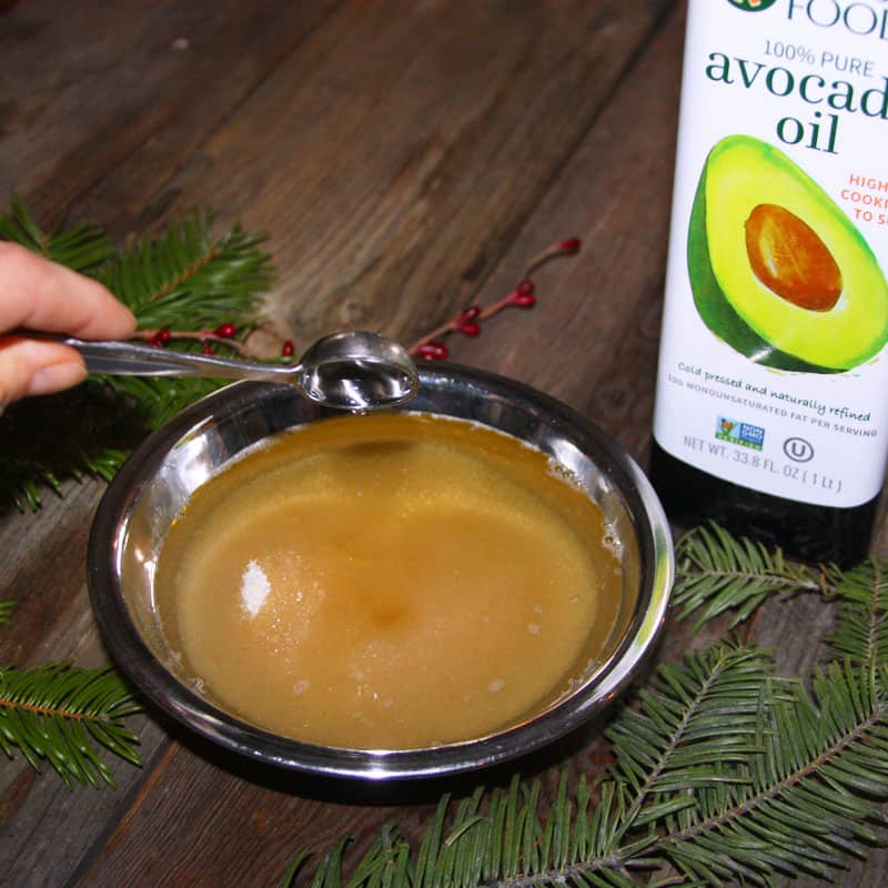 Adding avocado oil to homemade sugar scrub.