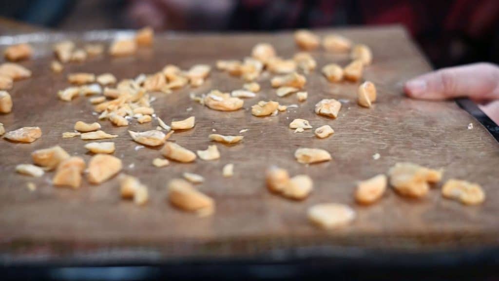 Dehydrated garlic cloves on a dehydrator tray.