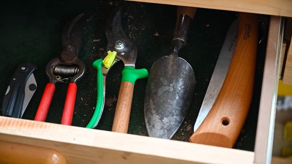 A drawer of hand tools for the garden.