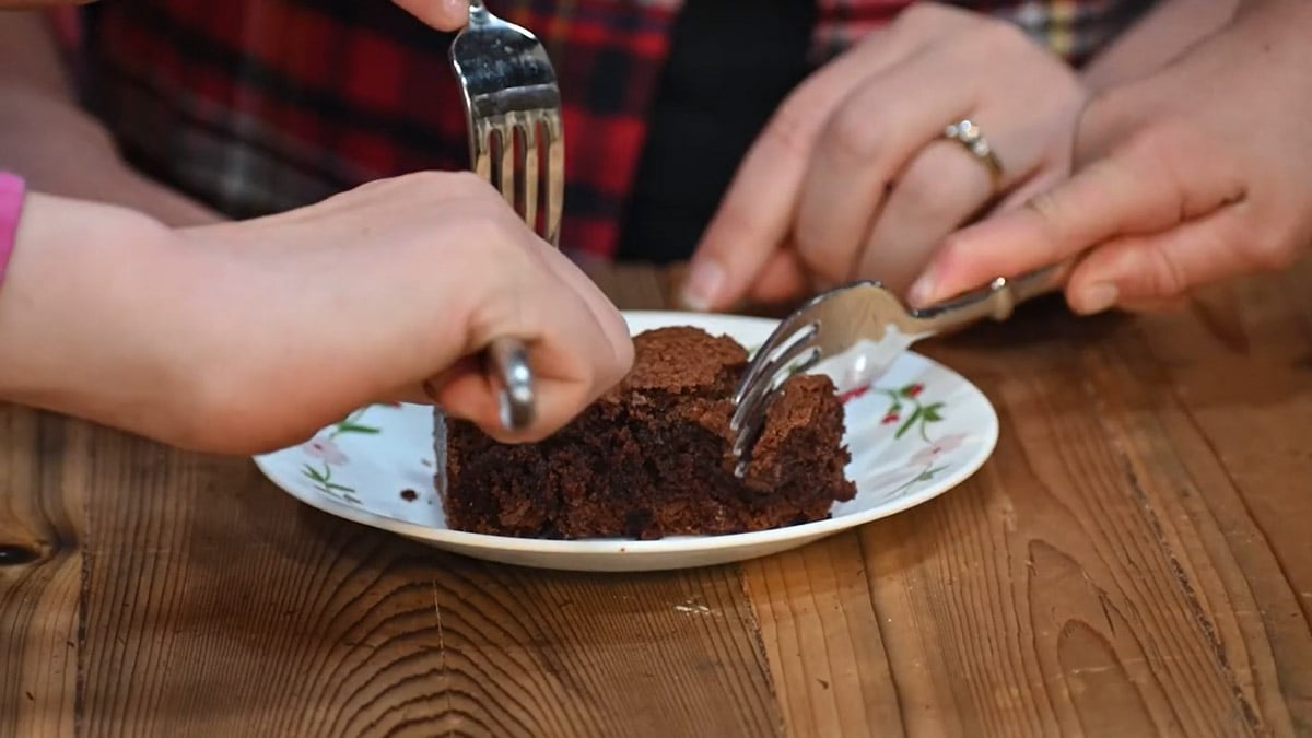 Forks going in for a bite of a brownie.
