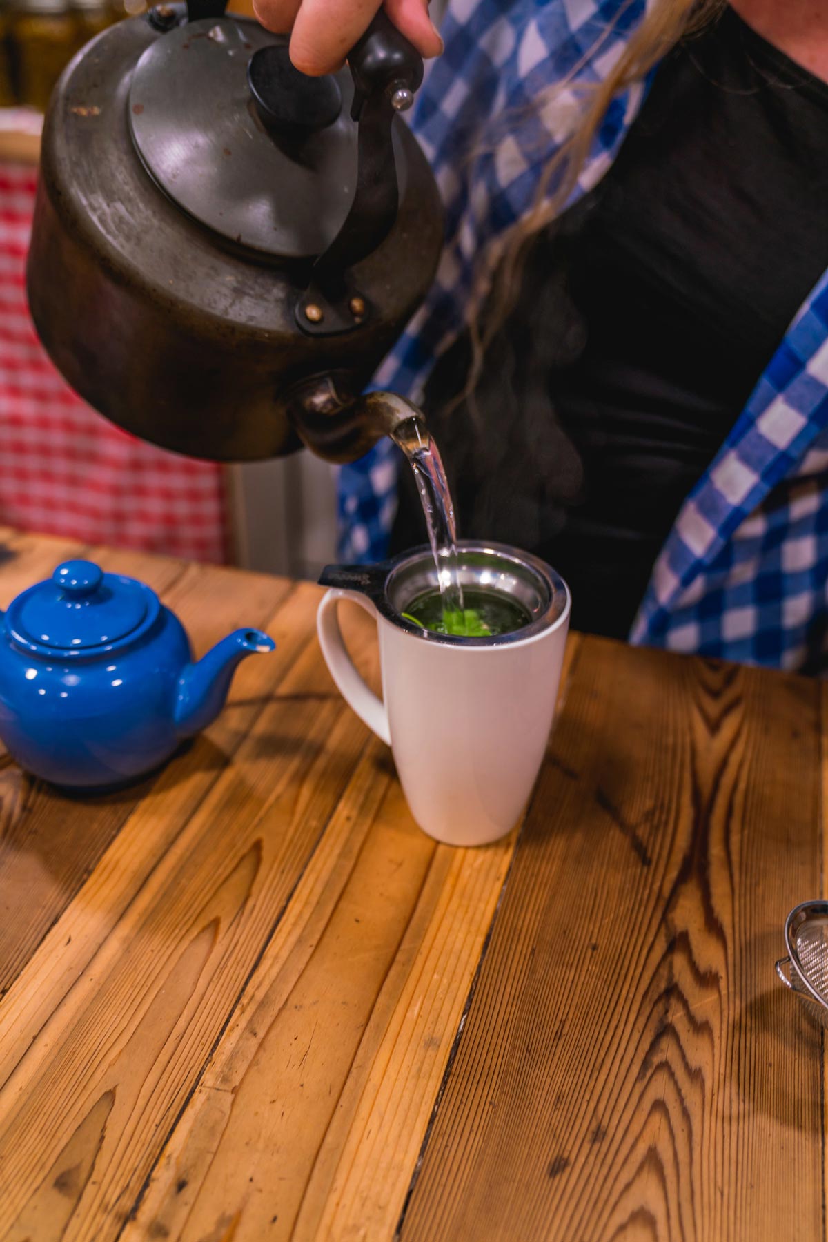 Hot water being poured over hops for tea.