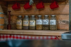 Jars of dried herbs on a counter.