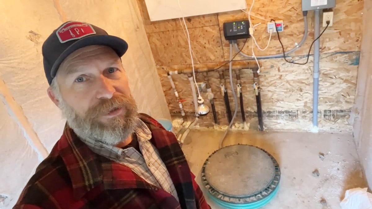 A man standing inside a pump house.