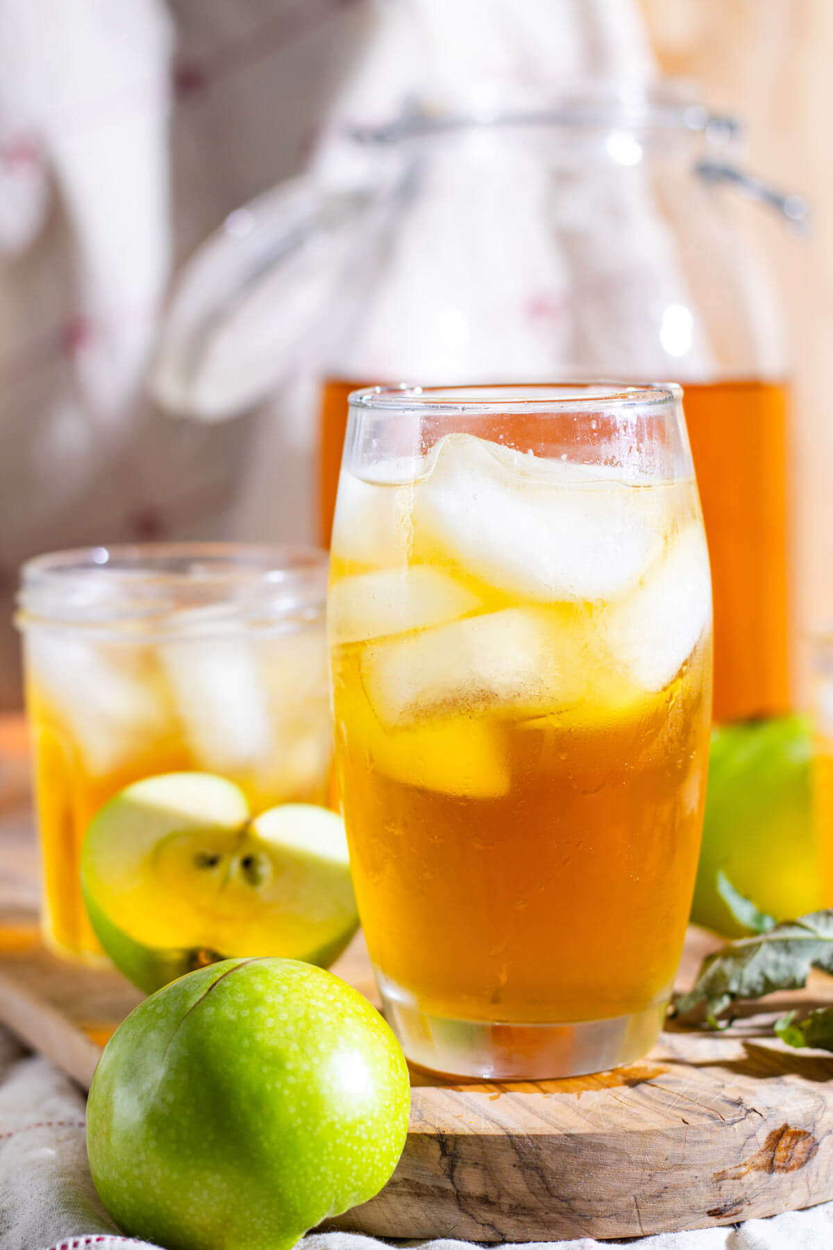 Sparkling apple cider served over ice in a glass.