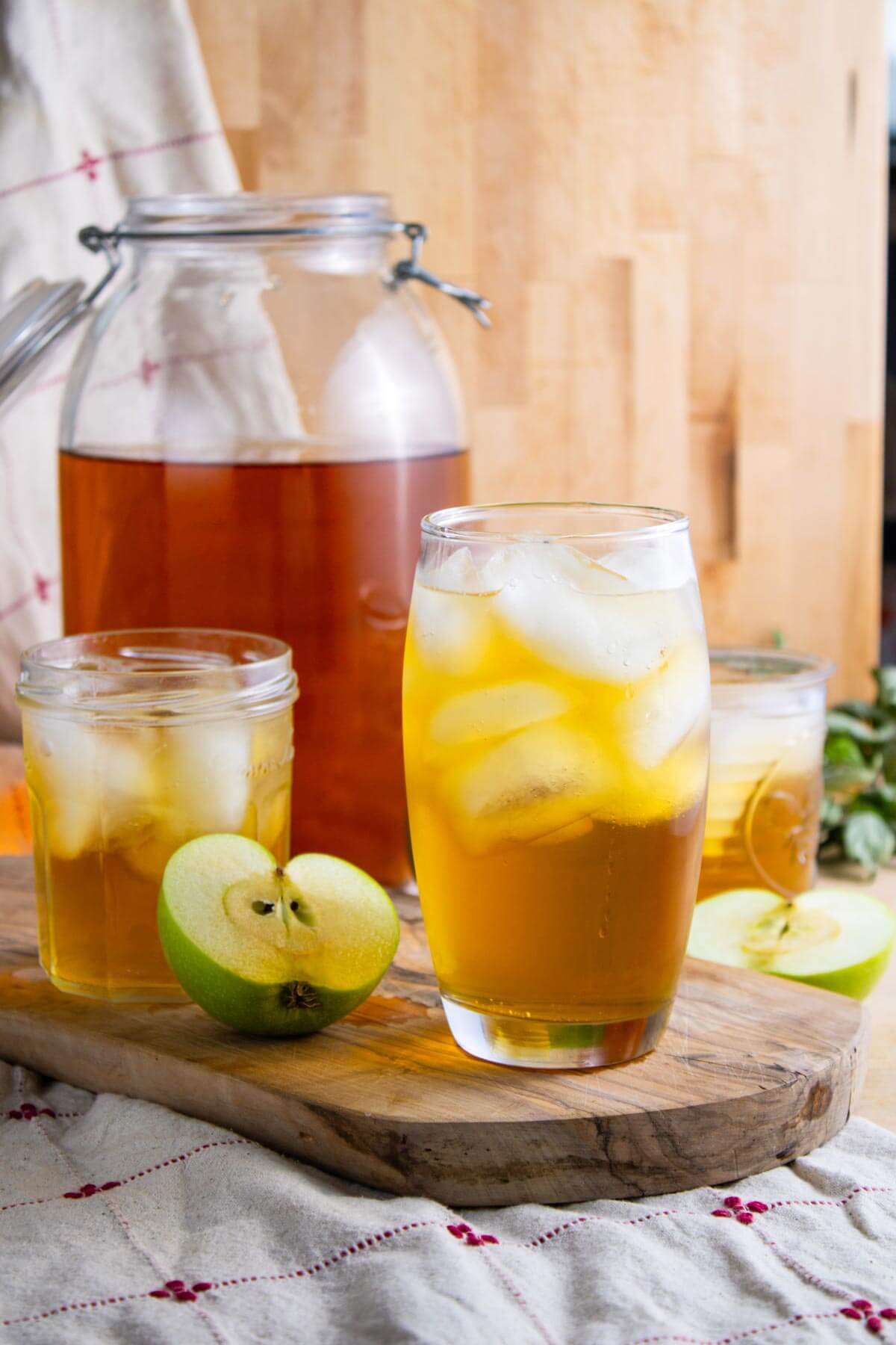 Sparkling apple cider served over ice in a glass.