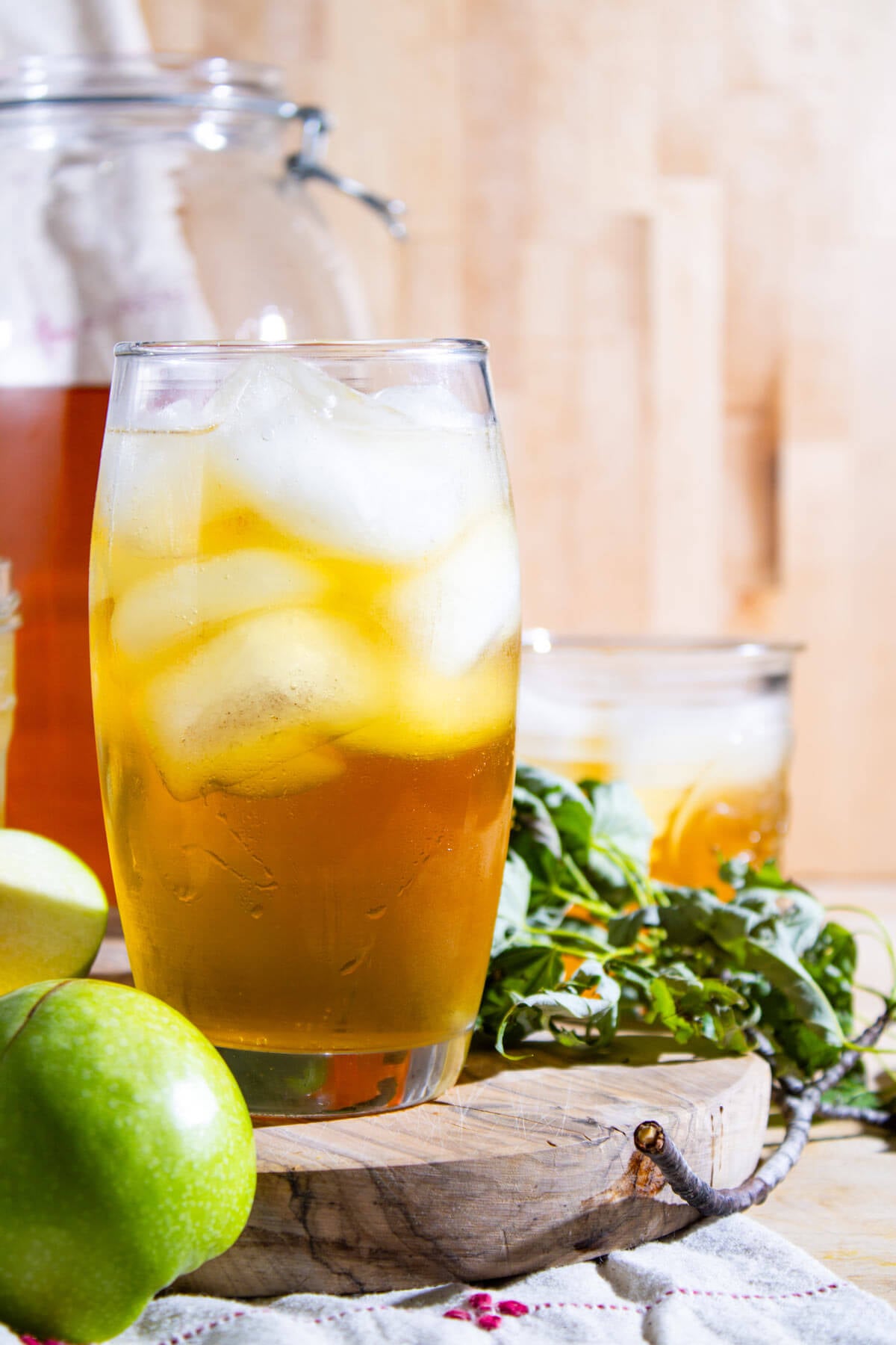 Sparkling apple cider served over ice in a glass.