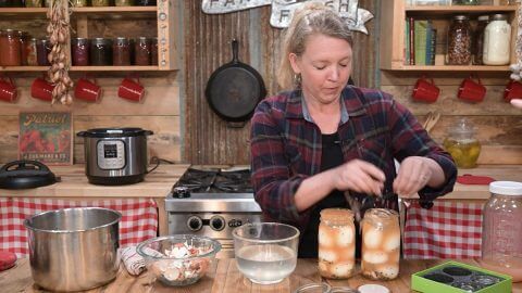 A woman making a funny face after making a mistake in the kitchen.