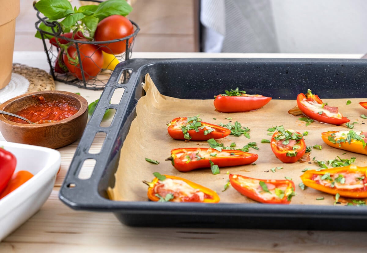 Bell pepper pizzas on a parchment lined baking sheet.