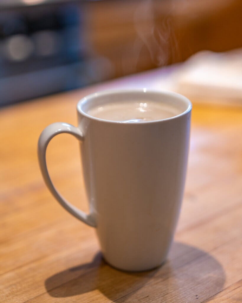 A white mug of dandelion root tea latte.