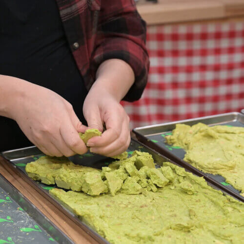 Freeze dried guacamole being crumbled.