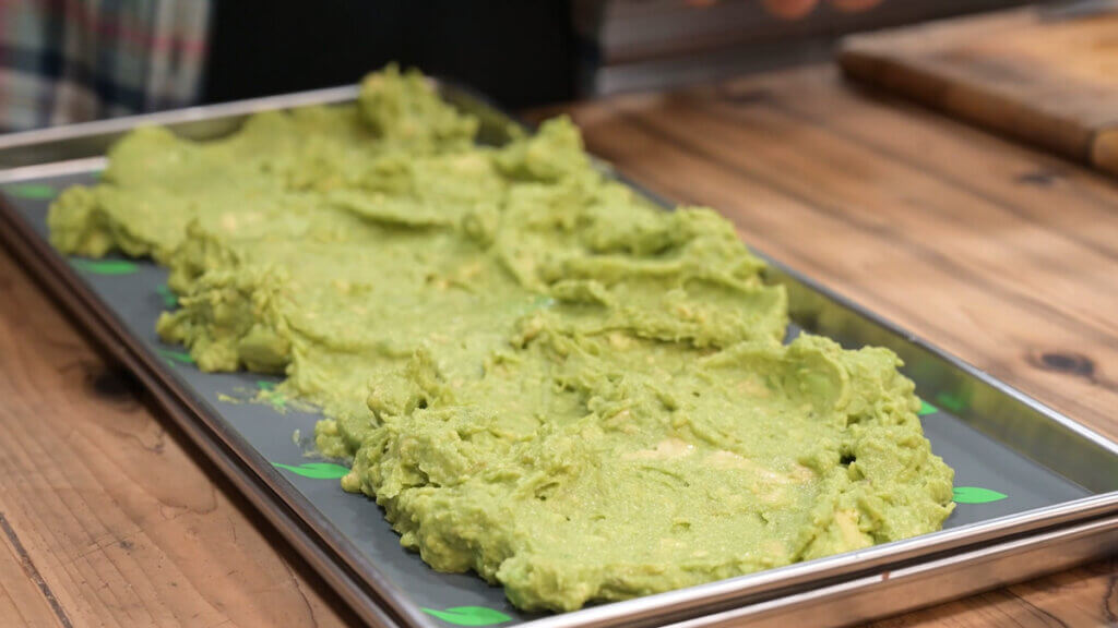 Guacamole spread out onto a freeze dryer tray.