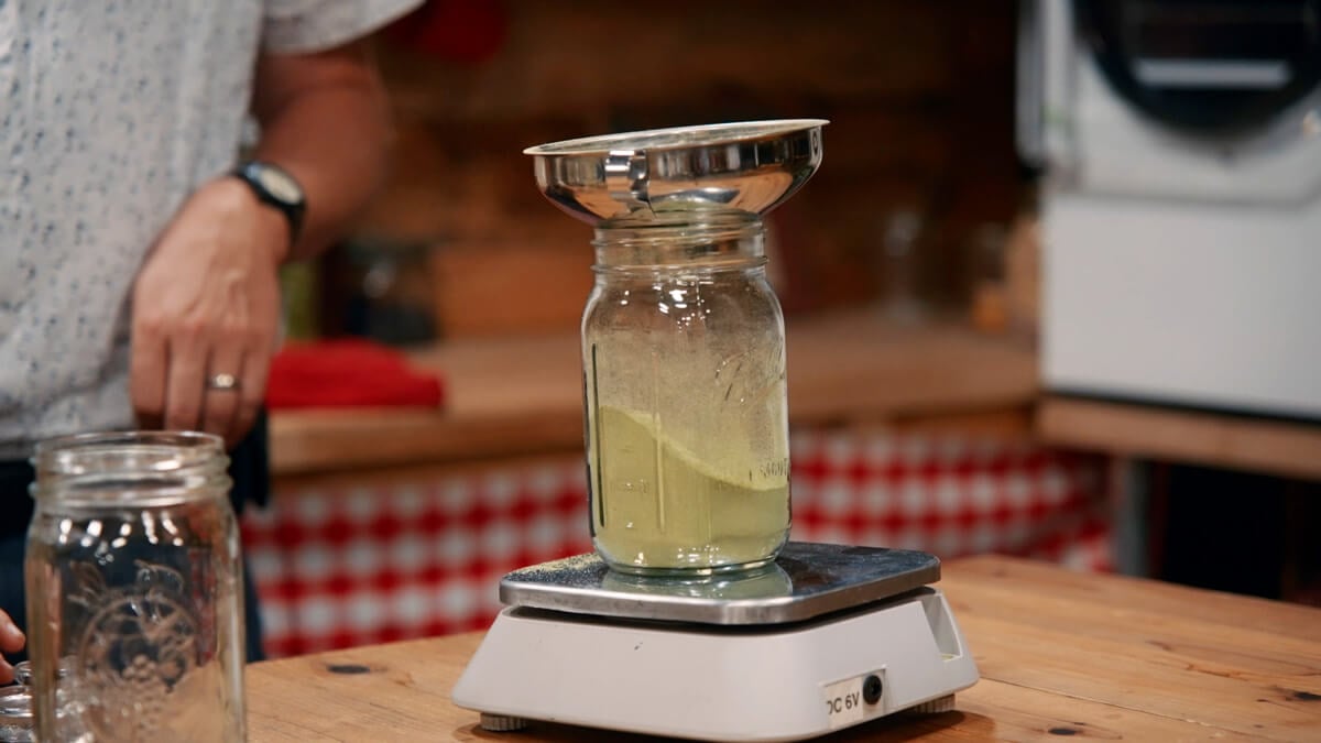 Dried ground hops being weighed.