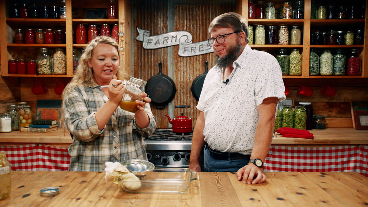 A man and woman making a hops tincture.