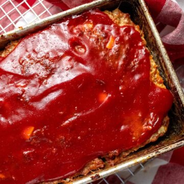 Close overhead view of glazed meatloaf in a loaf pan.