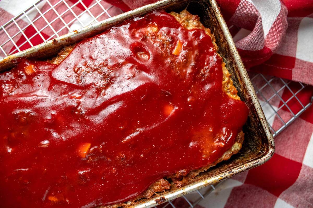 Close overhead view of glazed meatloaf in a loaf pan.
