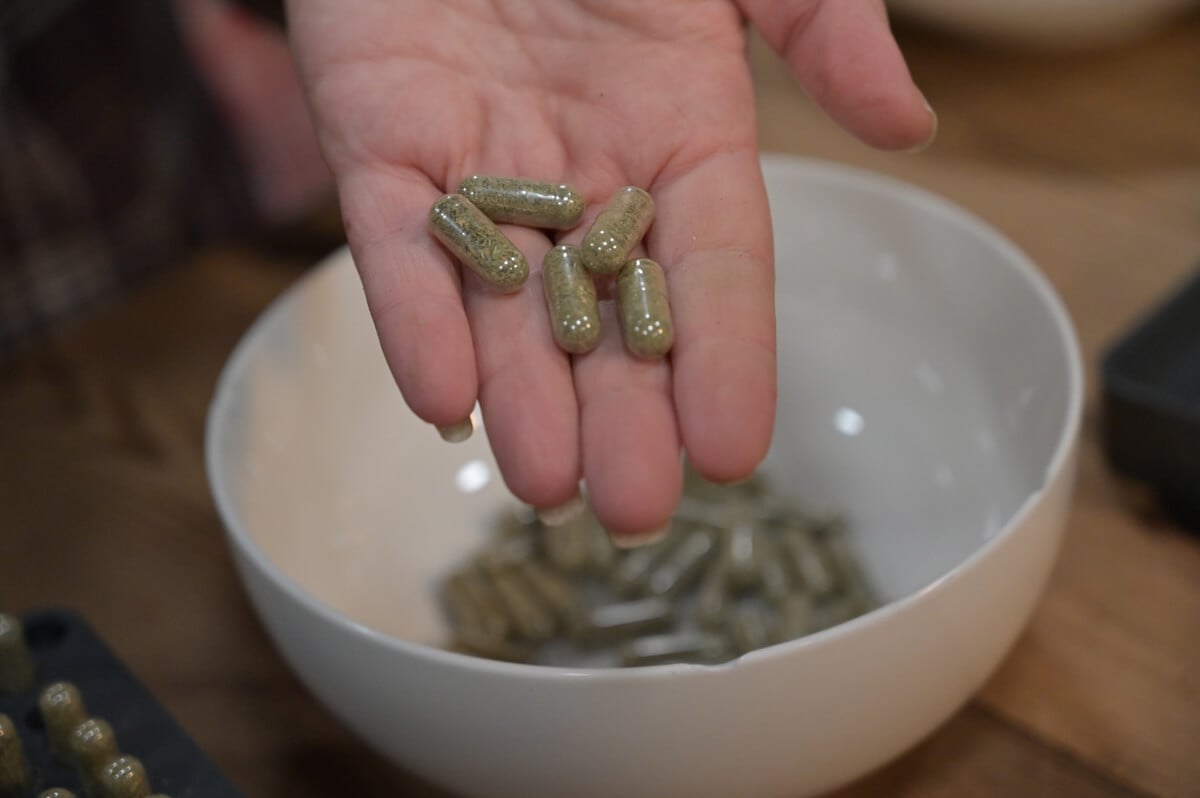 Allergy capsules in a woman's hand.