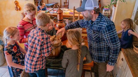 A father and kids making homemade vanilla ice cream.
