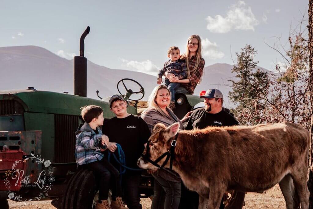 A family posing for a photo on a tractor.