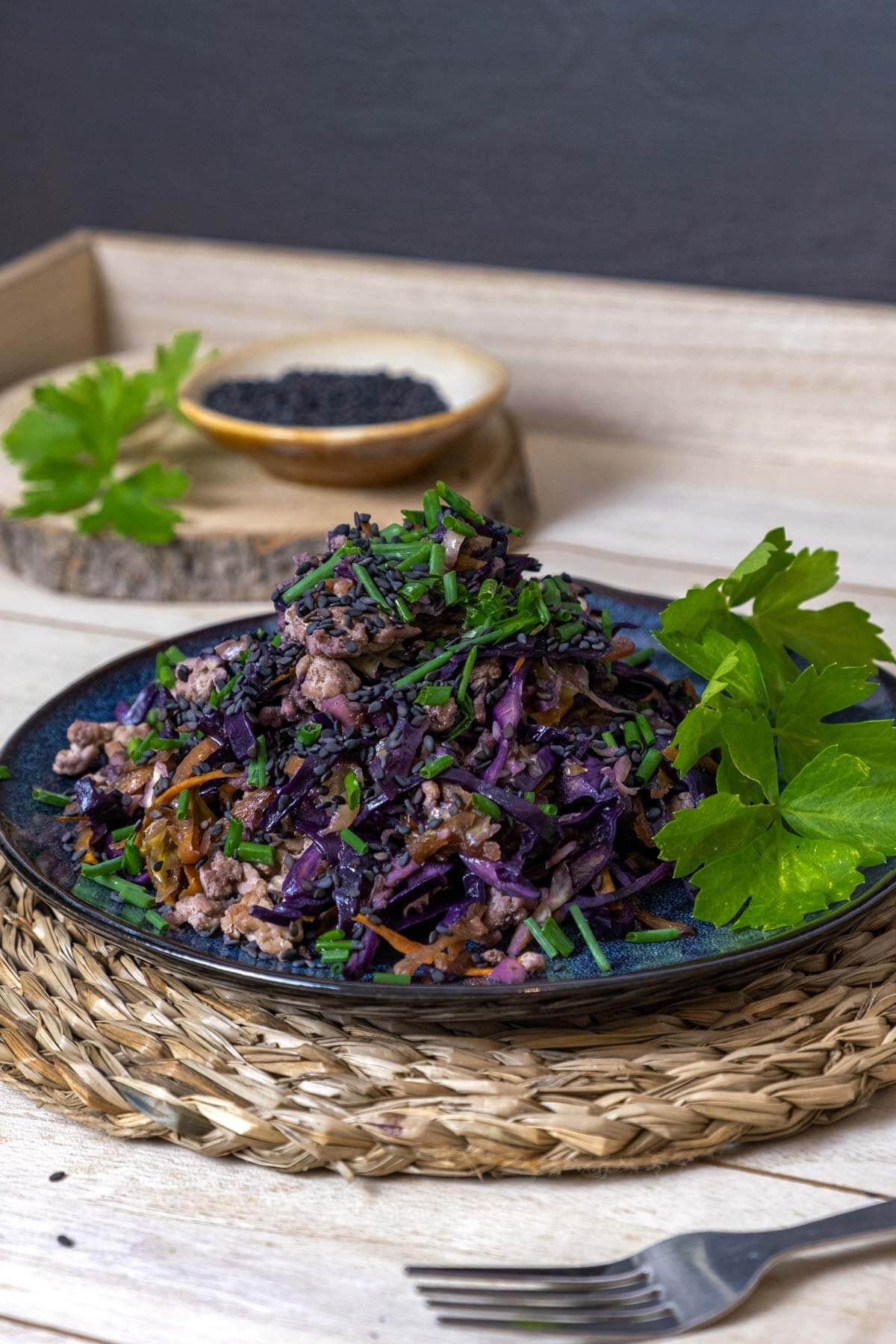 Vertical image of eggroll in a bowl on a plate.