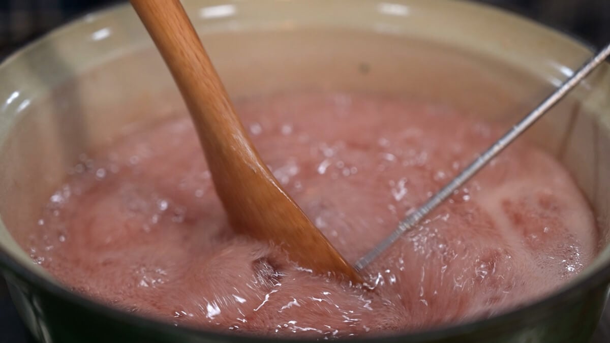 A pot of boiling elderberry gummy liquid.