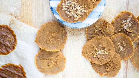 Overhead view of pumpkin leather on a blue-striped plate and wooden counter.