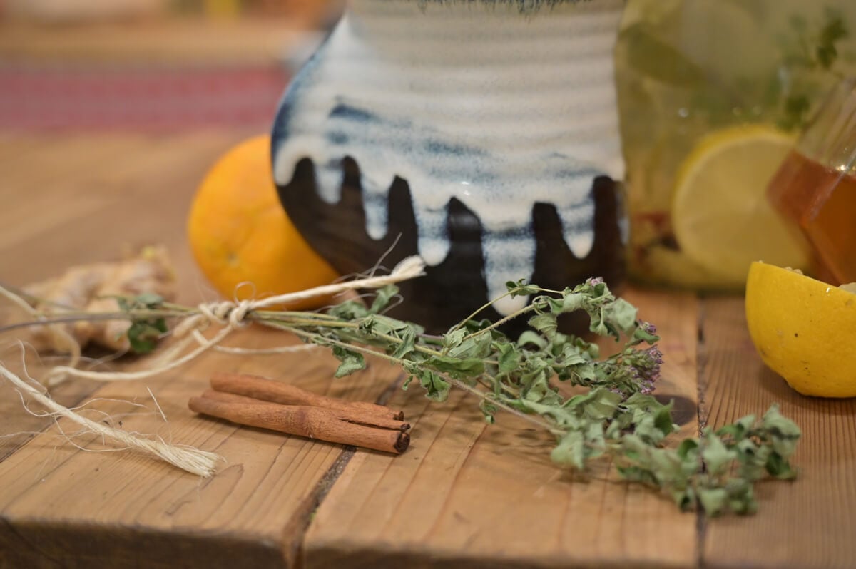 Herbal cold and flu ingredients on a wooden counter.