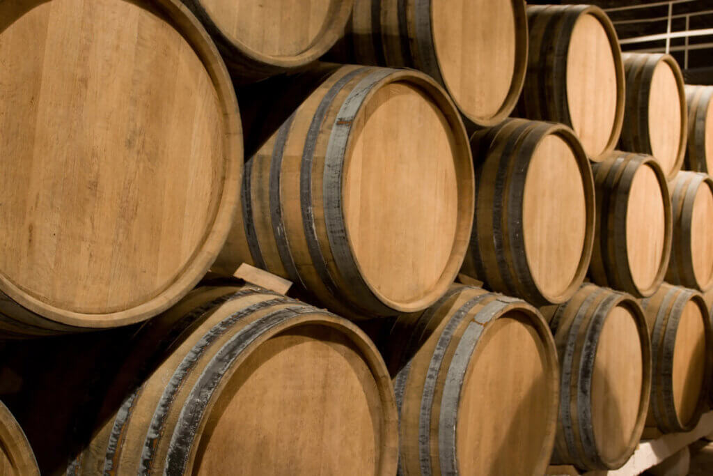 Wooden wine barrels stacked up.
