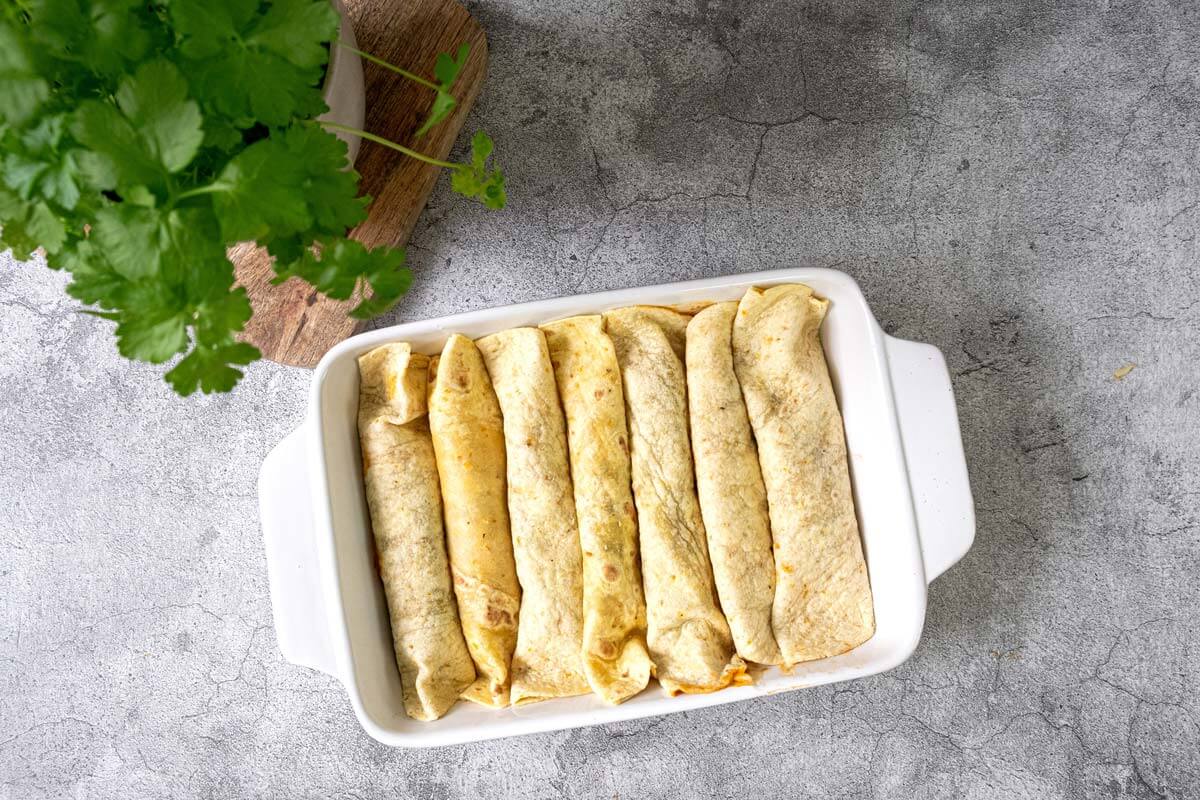 Black bean enchiladas in a casserole dish.