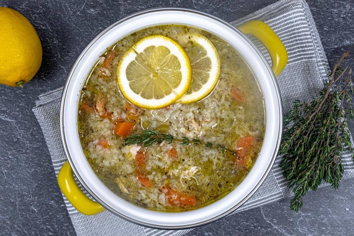 Greek lemon chicken soup in a yellow stock pot.