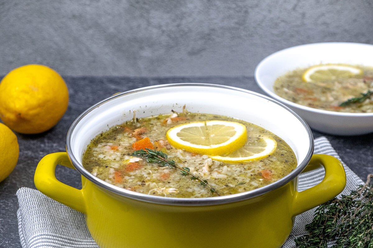 Greek lemon chicken soup in a yellow stock pot.