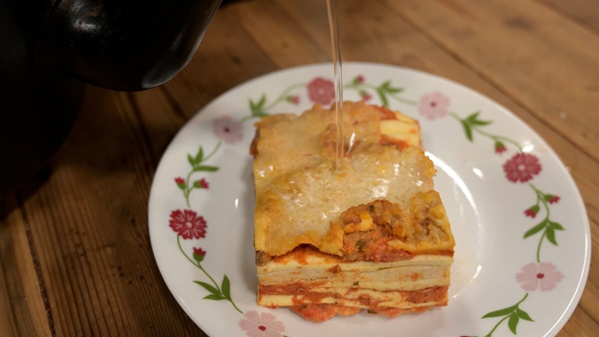 Boiling water being poured over freeze dried lasagna.