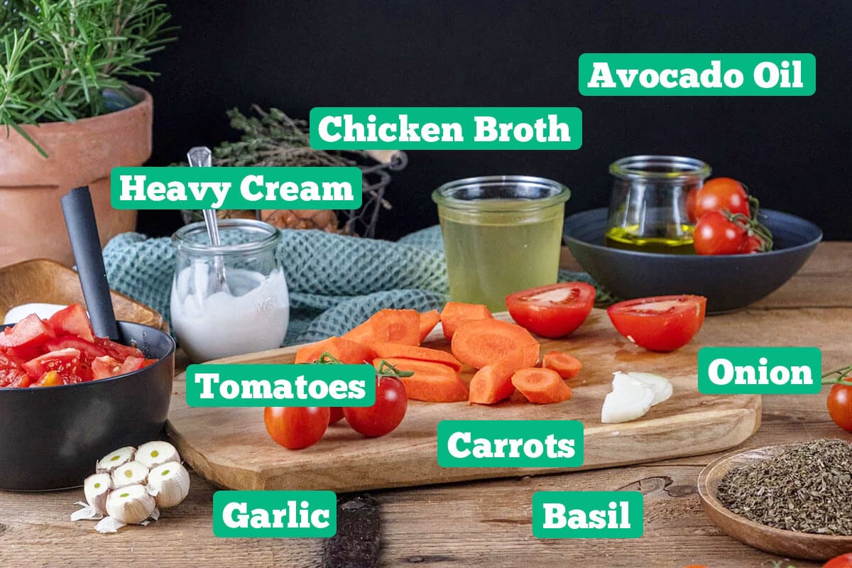 Instant Pot tomato soup ingredients: chicken broth, avocado oil, onion, carrots, tomatoes, and heavy cream.