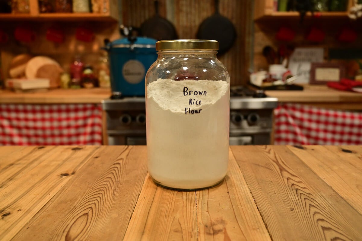 A gallon jar of ground brown rice flour.