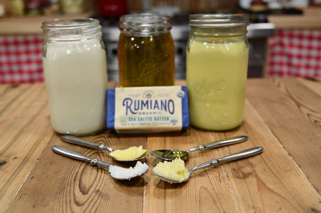 Photo of different fat sources on a wooden counter.