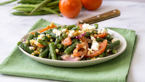 Green bean salad on a white plate.