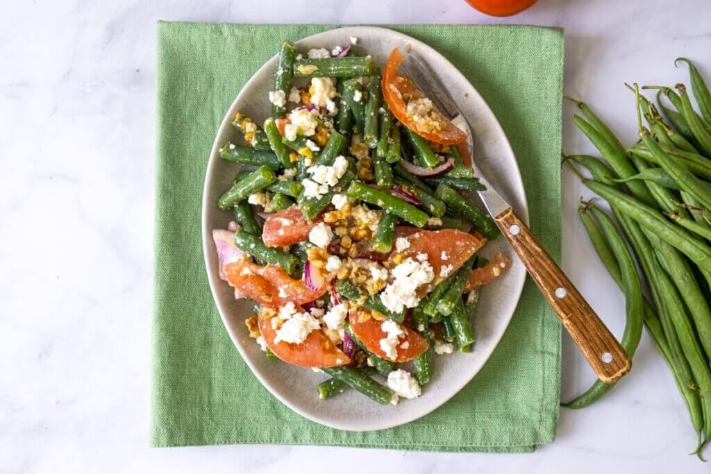 Green bean salad on a white plate.