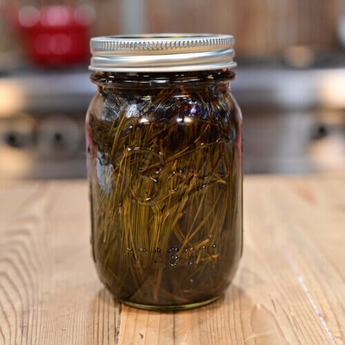 A pint-sized Mason jar filled with pine oil.